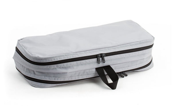 An empty and zipped closed Northwest Sky (light grey) Aether Small Laundry Aeronaut 45 Packing Cube all-fabric side up.